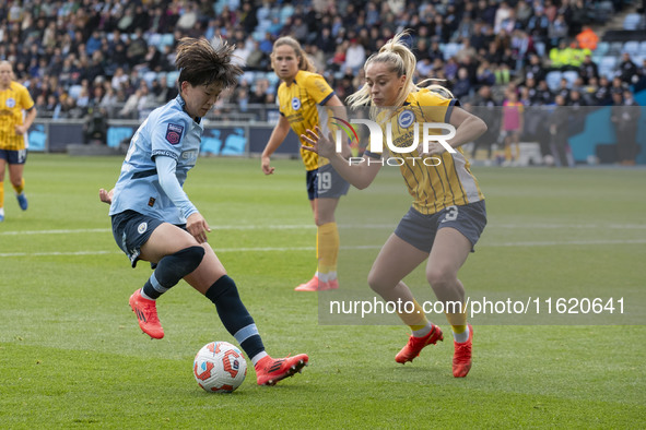 Aoba Fujino #20 of Manchester City W.F.C. is challenged by Poppy Pattinson #3 of Brighton & Hove Albion W.F.C. during the Barclays FA Women'...