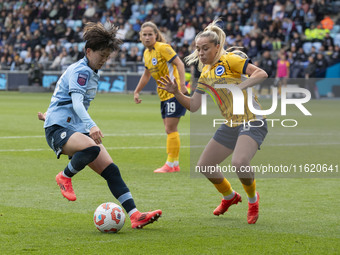 Aoba Fujino #20 of Manchester City W.F.C. is challenged by Poppy Pattinson #3 of Brighton & Hove Albion W.F.C. during the Barclays FA Women'...