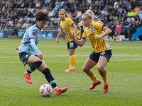 Aoba Fujino #20 of Manchester City W.F.C. is challenged by Poppy Pattinson #3 of Brighton & Hove Albion W.F.C. during the Barclays FA Women'...