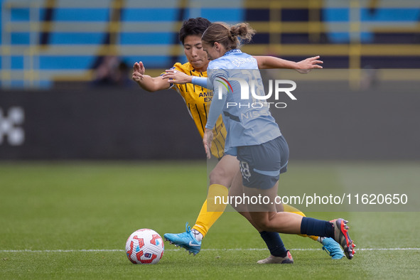 Kerstin Casparij #18 of Manchester City W.F.C. is challenged by Kiko Seike #11 of Brighton & Hove Albion W.F.C. during the Barclays FA Women...