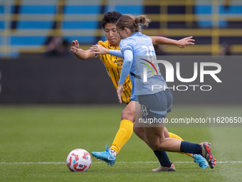 Kerstin Casparij #18 of Manchester City W.F.C. is challenged by Kiko Seike #11 of Brighton & Hove Albion W.F.C. during the Barclays FA Women...