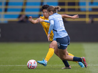 Kerstin Casparij #18 of Manchester City W.F.C. is challenged by Kiko Seike #11 of Brighton & Hove Albion W.F.C. during the Barclays FA Women...