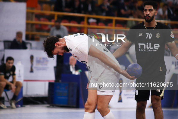 A Veszprem player holds the ball during his team's match against Zamalek in the Men's Handball Club World Championship in Cairo, Egypt, on O...