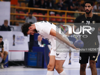 A Veszprem player holds the ball during his team's match against Zamalek in the Men's Handball Club World Championship in Cairo, Egypt, on O...