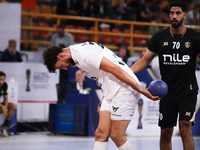 A Veszprem player holds the ball during his team's match against Zamalek in the Men's Handball Club World Championship in Cairo, Egypt, on O...