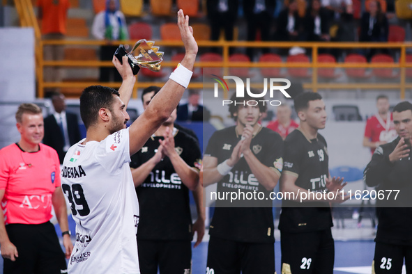 Yehia El-Deraa of Veszprem celebrates with fans after receiving the Man of the Match award in his team's match against Zamalek in the Men's...