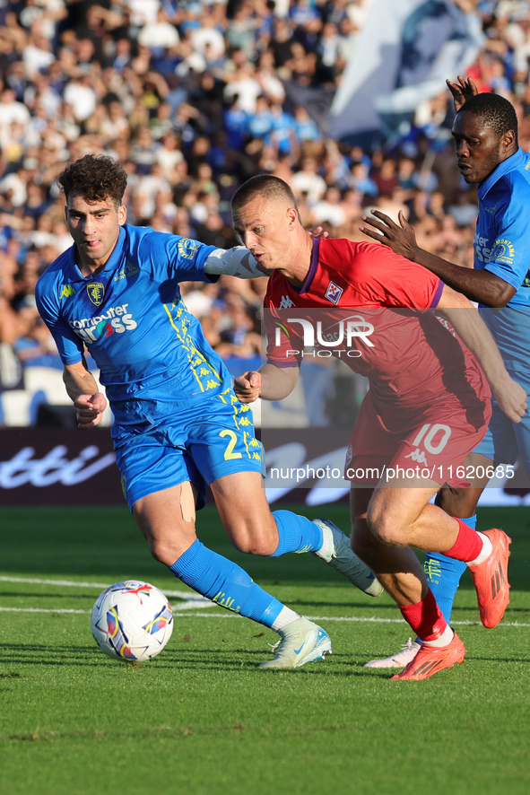 Saba Goglichidze of Empoli FC and Albert Gudmundsson of ACF Fiorentina battle for the ball during the Serie A match between Empoli FC and AC...