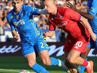 Saba Goglichidze of Empoli FC and Albert Gudmundsson of ACF Fiorentina battle for the ball during the Serie A match between Empoli FC and AC...