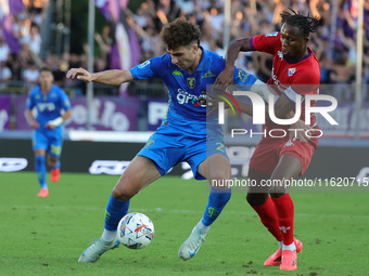 Saba Goglichidze of Empoli FC and Christian Kouame of ACF Fiorentina battle for the ball during the Serie A match between Empoli FC and ACF...