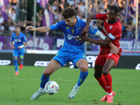 Saba Goglichidze of Empoli FC and Christian Kouame of ACF Fiorentina battle for the ball during the Serie A match between Empoli FC and ACF...