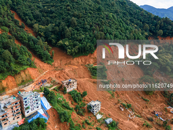 A drone view shows roadblocks on Charghare caused by landslides due to heavy rainfall in southern Lalitpur, Nepal, on September 29, 2024. (