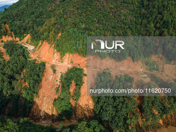 A drone view shows roadblocks on Charghare caused by landslides due to heavy rainfall in southern Lalitpur, Nepal, on September 29, 2024. 