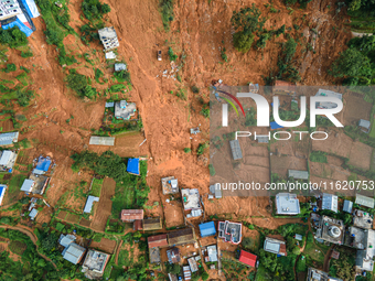 A drone view shows roadblocks on Charghare caused by landslides due to heavy rainfall in southern Lalitpur, Nepal, on September 29, 2024. (