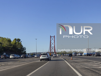 Cars drive near the 25 de Abril bridge in Lisbon, Portugal, on September 29, 2024. Data from the Portuguese Association of Highway Concessio...