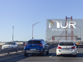 Cars drive near the 25 de Abril bridge in Lisbon, Portugal, on September 29, 2024. Data from the Portuguese Association of Highway Concessio...