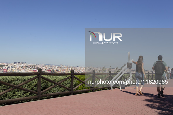 People walk near the Cristo Rei monument in Lisbon, Portugal, on September 29, 2024. Cristo Rei attracts pilgrims, tourists, and visitors fr...