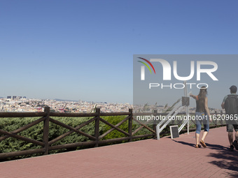 People walk near the Cristo Rei monument in Lisbon, Portugal, on September 29, 2024. Cristo Rei attracts pilgrims, tourists, and visitors fr...