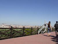 People walk near the Cristo Rei monument in Lisbon, Portugal, on September 29, 2024. Cristo Rei attracts pilgrims, tourists, and visitors fr...