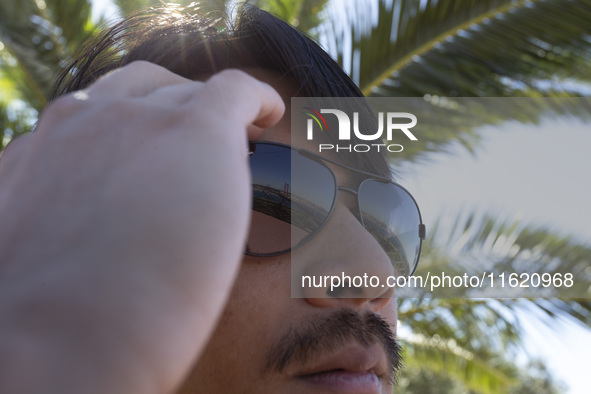 The 25 de Abril Bridge is reflected in a person's sunglasses in Lisbon, Portugal, on September 29, 2024. Cristo Rei attracts pilgrims, touri...