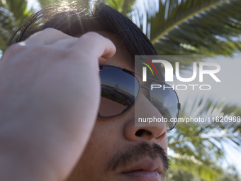 The 25 de Abril Bridge is reflected in a person's sunglasses in Lisbon, Portugal, on September 29, 2024. Cristo Rei attracts pilgrims, touri...