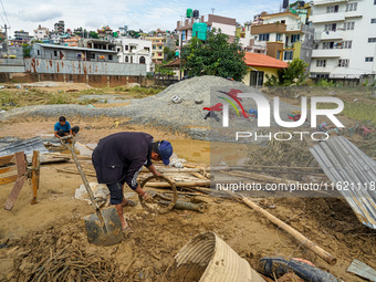 People's daily lives are affected after heavy rainfall and flooding of the Nakhu River in Lalitpur, Nepal, on September 29, 2024. People gat...