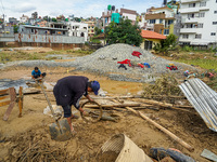 People's daily lives are affected after heavy rainfall and flooding of the Nakhu River in Lalitpur, Nepal, on September 29, 2024. People gat...