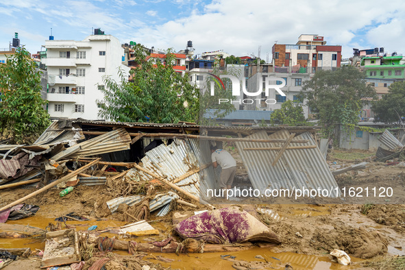 People's daily lives are affected after heavy rainfall and flooding of the Nakhu River in Lalitpur, Nepal, on September 29, 2024. People gat...