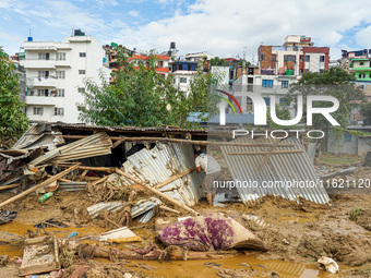 People's daily lives are affected after heavy rainfall and flooding of the Nakhu River in Lalitpur, Nepal, on September 29, 2024. People gat...