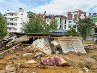 People's daily lives are affected after heavy rainfall and flooding of the Nakhu River in Lalitpur, Nepal, on September 29, 2024. People gat...