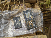 A damaged mobile phone is found while cleaning mud in the residential area along the Nakhu River bank in Lalitpur, Nepal, on September 29, 2...