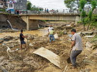 People's daily lives are affected after heavy rainfall and flooding of the Nakhu River in Lalitpur, Nepal, on September 29, 2024. People cle...