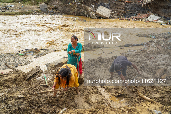 People's daily lives are affected after heavy rainfall and flooding of the Nakhu River in Lalitpur, Nepal, on September 29, 2024. People cle...