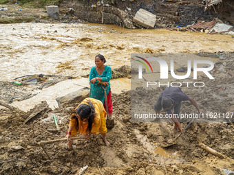 People's daily lives are affected after heavy rainfall and flooding of the Nakhu River in Lalitpur, Nepal, on September 29, 2024. People cle...