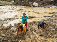 People's daily lives are affected after heavy rainfall and flooding of the Nakhu River in Lalitpur, Nepal, on September 29, 2024. People cle...