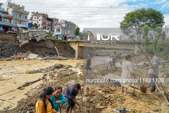 People's daily lives are affected after heavy rainfall and flooding of the Nakhu River in Lalitpur, Nepal, on September 29, 2024. People cle...