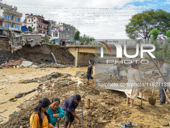 People's daily lives are affected after heavy rainfall and flooding of the Nakhu River in Lalitpur, Nepal, on September 29, 2024. People cle...