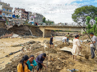 People's daily lives are affected after heavy rainfall and flooding of the Nakhu River in Lalitpur, Nepal, on September 29, 2024. People cle...