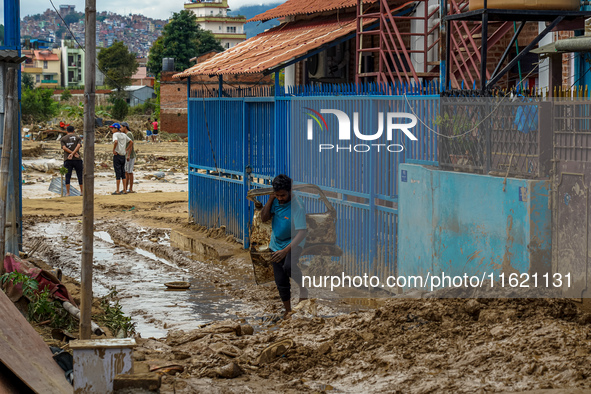 People's daily lives are affected after heavy rainfall and flooding of the Nakhu River in Lalitpur, Nepal, on September 29, 2024. 