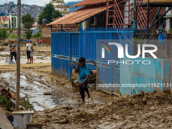 People's daily lives are affected after heavy rainfall and flooding of the Nakhu River in Lalitpur, Nepal, on September 29, 2024. (