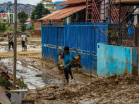 People's daily lives are affected after heavy rainfall and flooding of the Nakhu River in Lalitpur, Nepal, on September 29, 2024. (