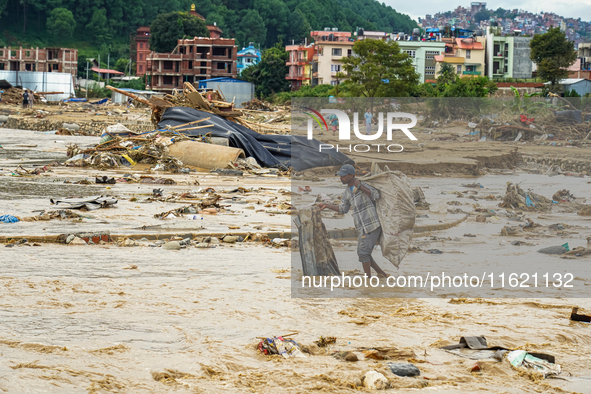 People's daily lives are affected after heavy rainfall and flooding of the Nakhu River in Lalitpur, Nepal, on September 29, 2024. 