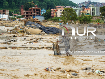 People's daily lives are affected after heavy rainfall and flooding of the Nakhu River in Lalitpur, Nepal, on September 29, 2024. (