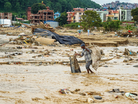 People's daily lives are affected after heavy rainfall and flooding of the Nakhu River in Lalitpur, Nepal, on September 29, 2024. (