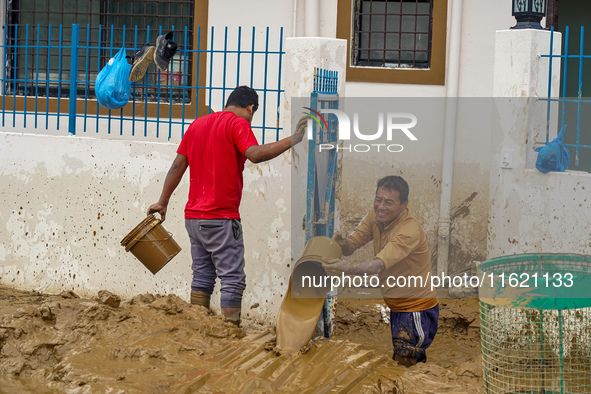 People's daily lives are affected after heavy rainfall and flooding of the Nakhu River in Lalitpur, Nepal, on September 29, 2024. People cle...