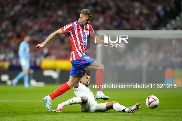 Alexander Sorloth centre-forward of Atletico de Madrid and Norway and Eder Militao centre-back of Real Madrid and Brazil compete for the bal...