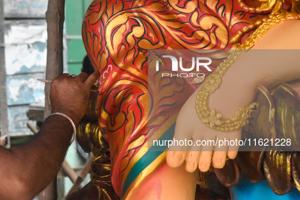 An artisan paints an idol of the Hindu goddess Durga at a workshop ahead of the Durga Puja festival in Kolkata, India, on September 29, 2024...