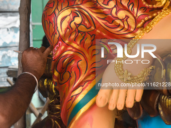 An artisan paints an idol of the Hindu goddess Durga at a workshop ahead of the Durga Puja festival in Kolkata, India, on September 29, 2024...