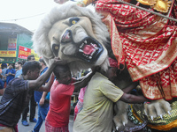 Labourers pull an idol of Durga through a street to be transported on a truck to a pandal, or a temporary platform, for the upcoming festiva...