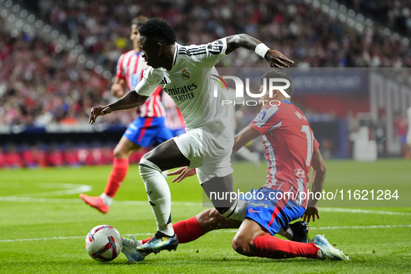 Vinicius Junior left winger of Real Madrid and Brazil and Nahuel Molina right-back of Atletico de Madrid and Argentina compete for the ball...