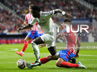 Vinicius Junior left winger of Real Madrid and Brazil and Nahuel Molina right-back of Atletico de Madrid and Argentina compete for the ball...